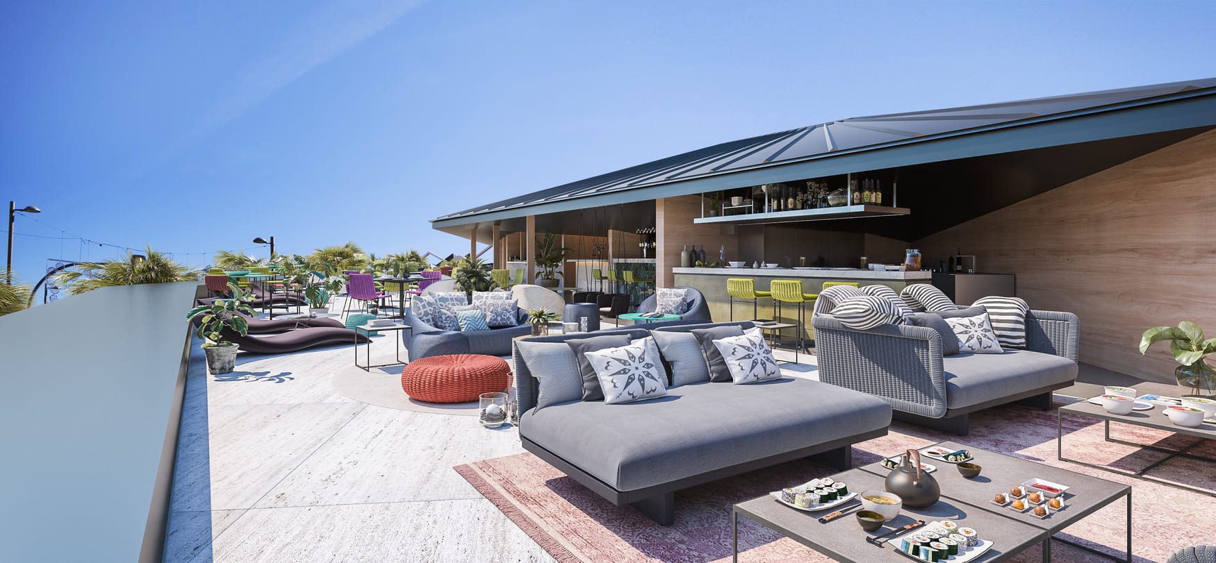 Terraza superior ajardinada con mobiliario lounge, sombrillas y vistas al paisaje urbano junto a zona de bar